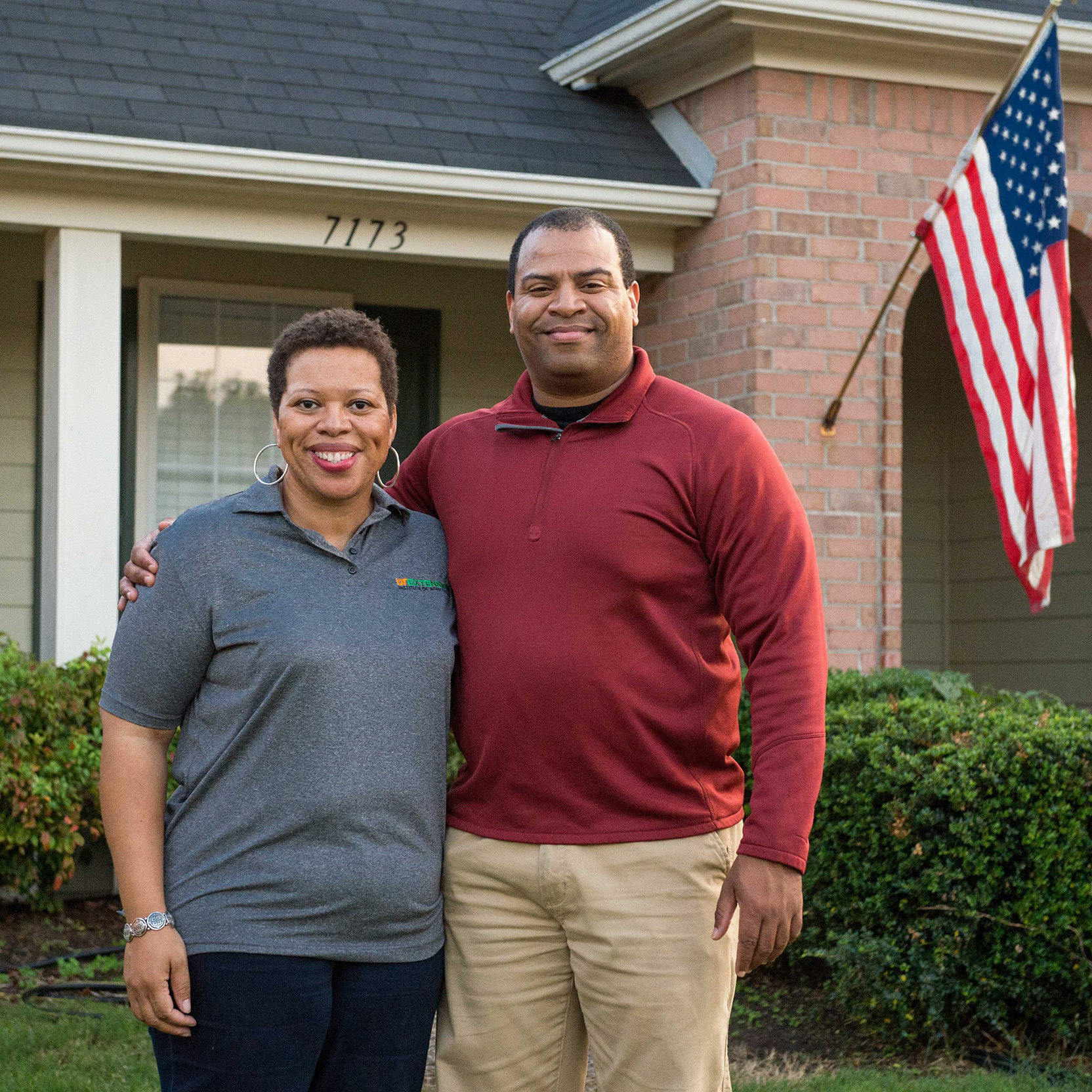 Man and woman in front of house 