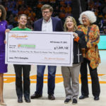 A giant check being held up at a UT Basketball game