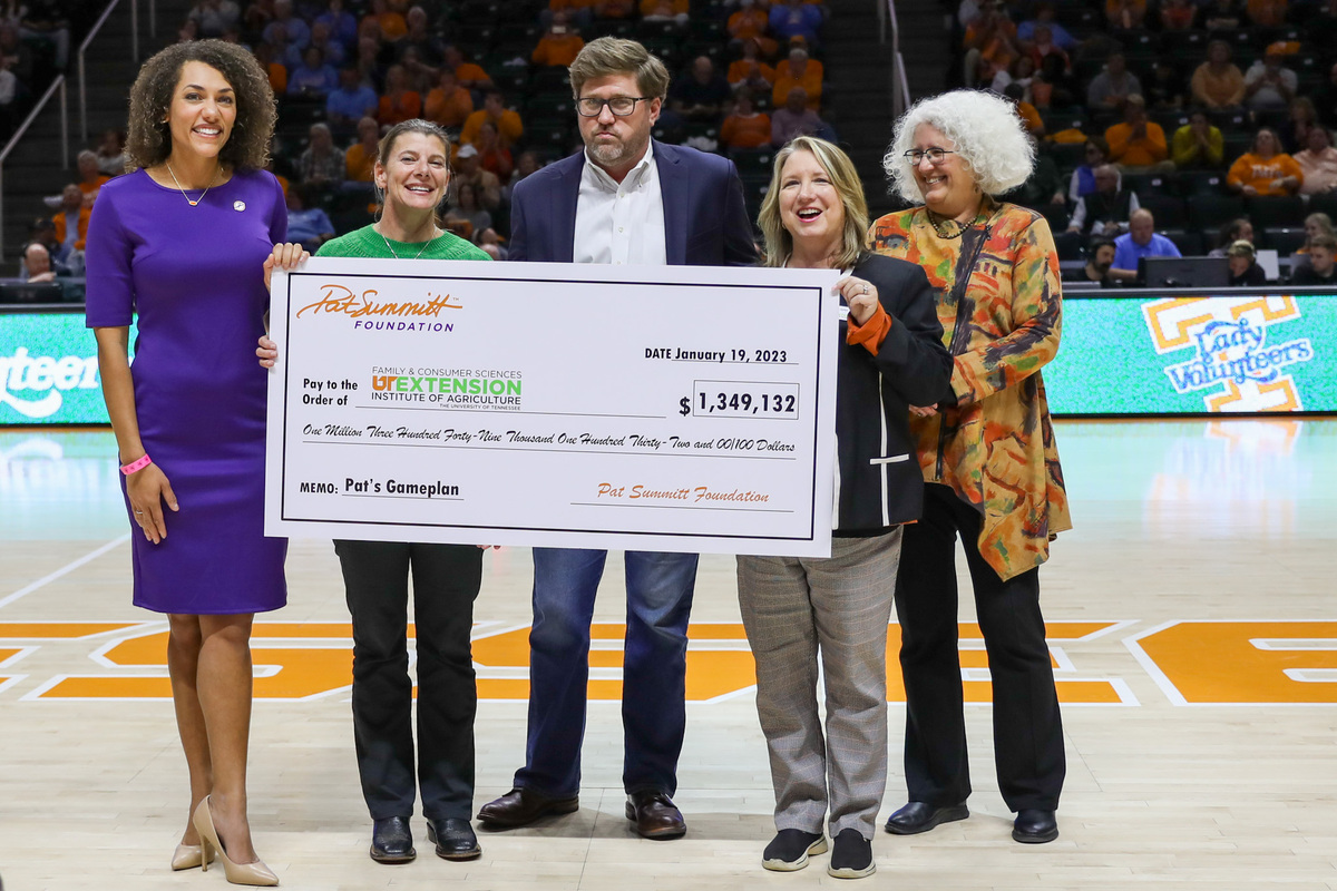 A giant check being held up at a UT Basketball game
