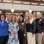 Instructors Megan Leffew, Michelle Childs, Heejin (Jeanie) Lim, Myra Loveday, and Chris Sneed with employees at the UT Creamery in the background.