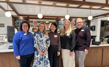 Instructors Megan Leffew, Michelle Childs, Heejin (Jeanie) Lim, Myra Loveday, and Chris Sneed with employees at the UT Creamery in the background.